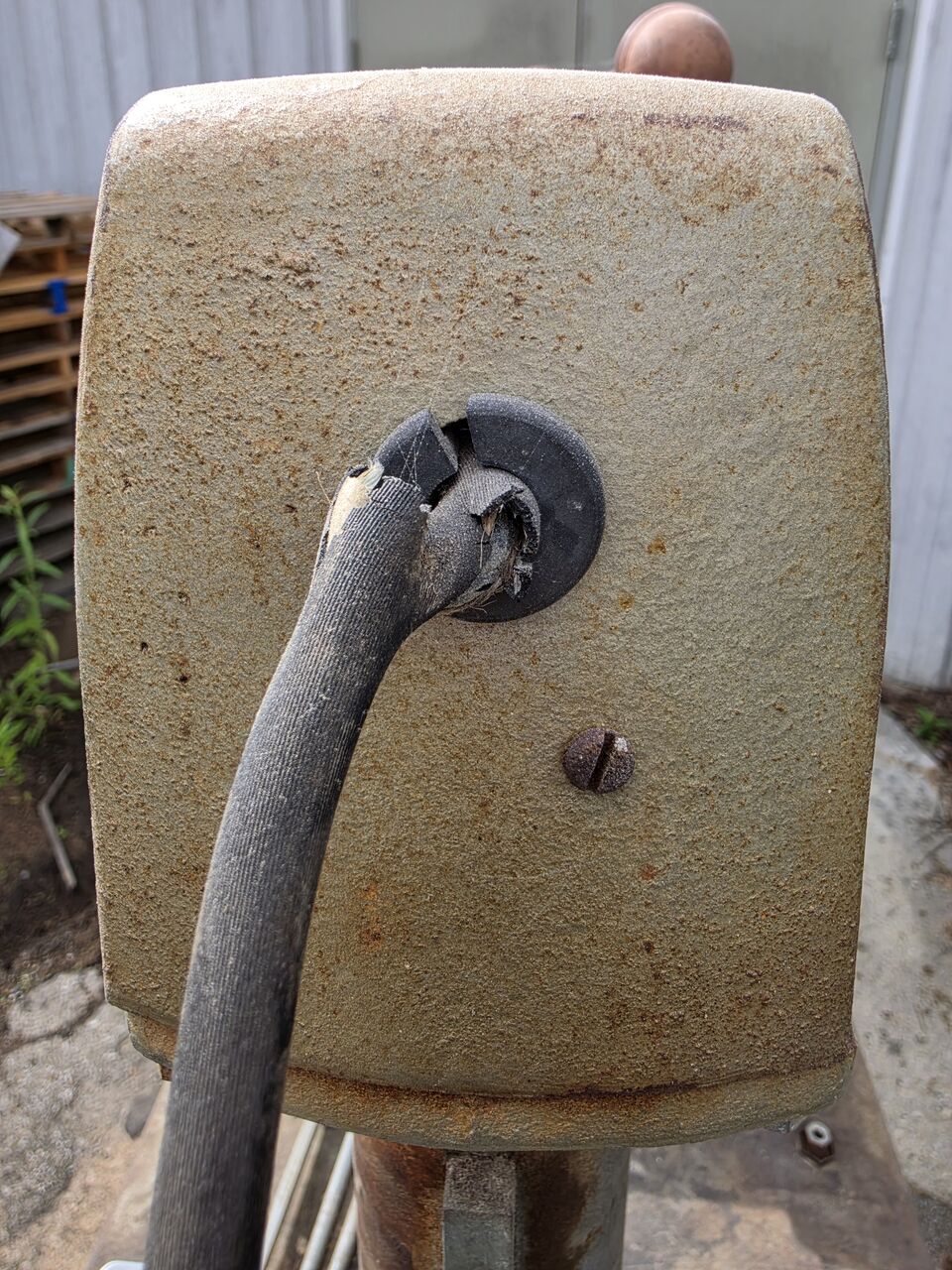 Cord entering the rear of the carriage through a broken grommet, with the cloth covering torn