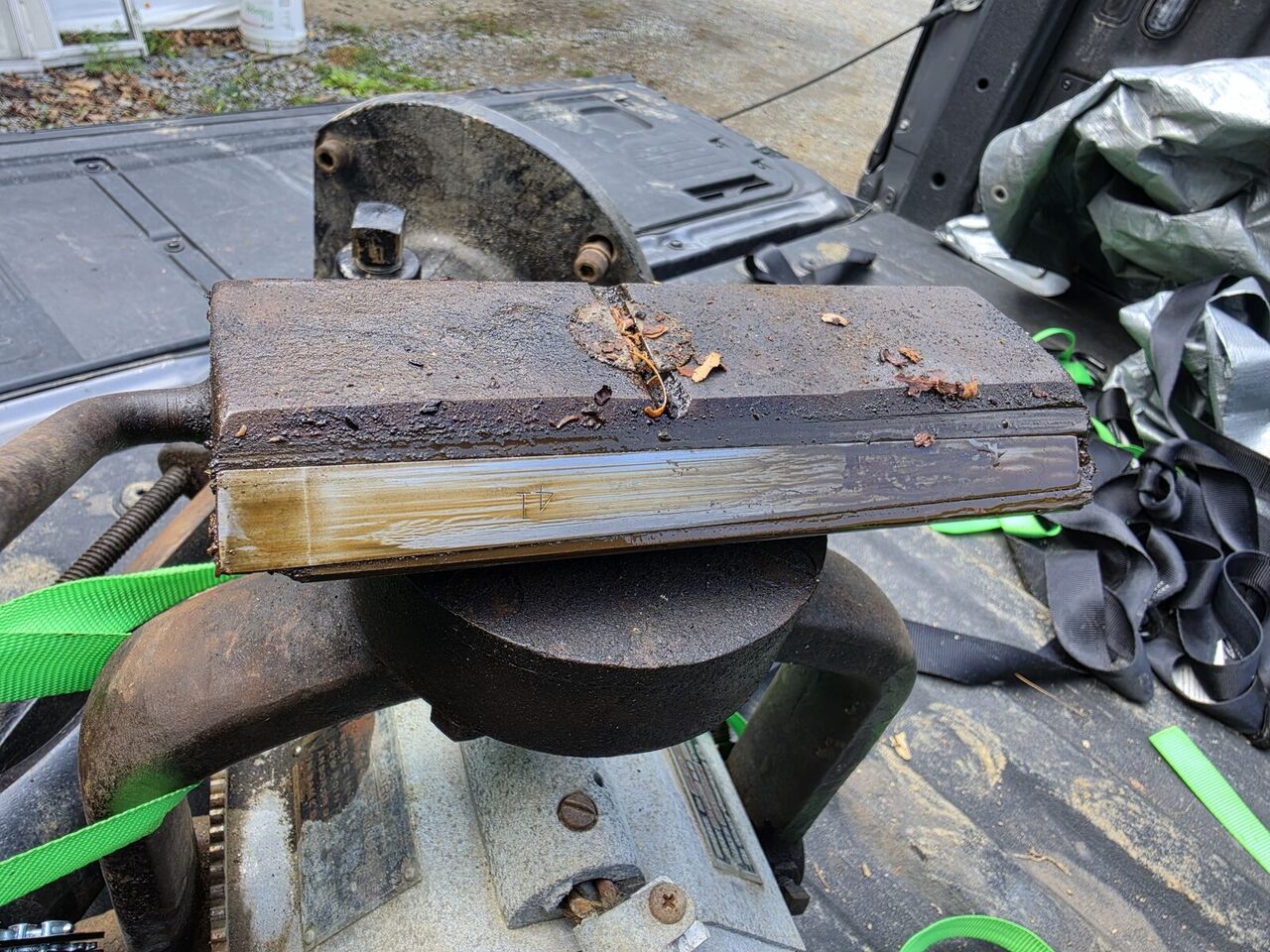 Stamped cast block removed from the saw, resting on the tailgate of the truck