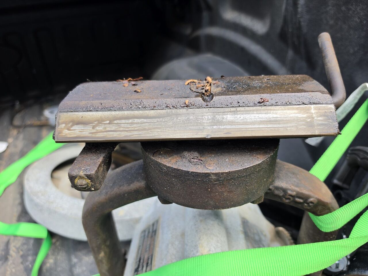 Cast block seen from the side, showing the machined face and the pivot beneath it