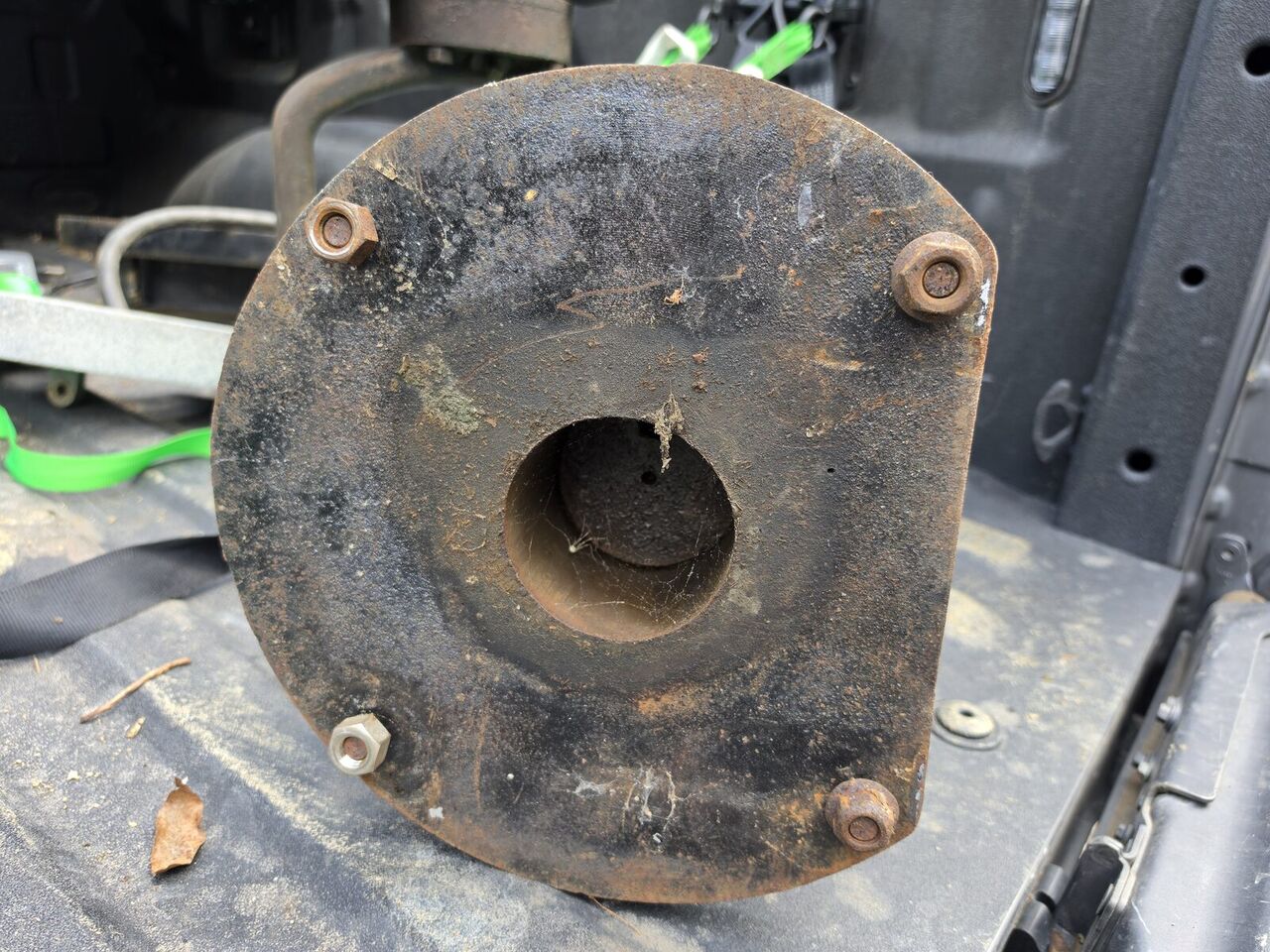 Underside of the column flange with its four bolts and a stamped arrow mark