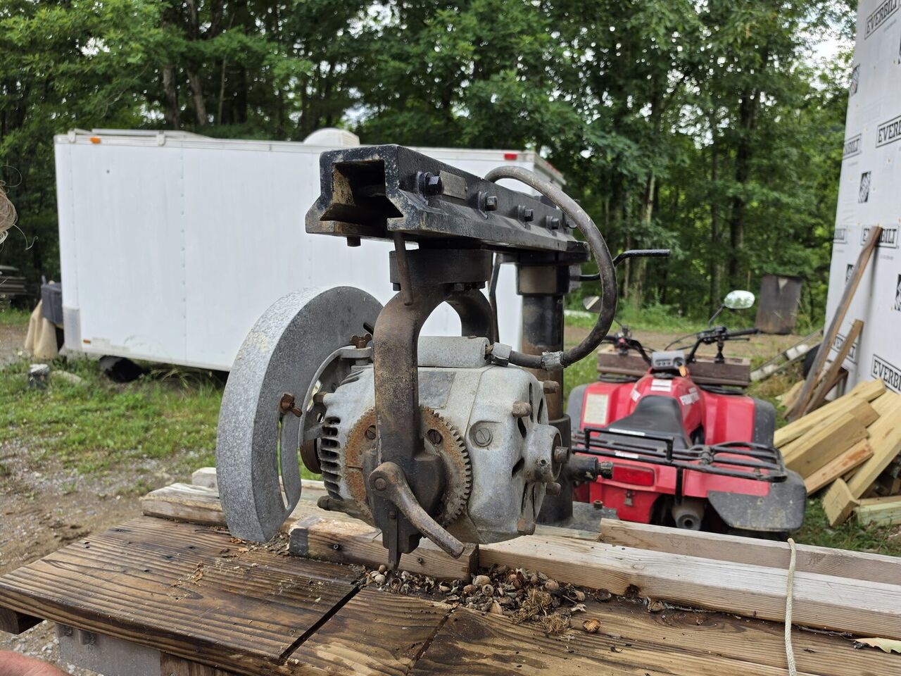 The reassembled saw set up outdoors, viewed from the blade guard side